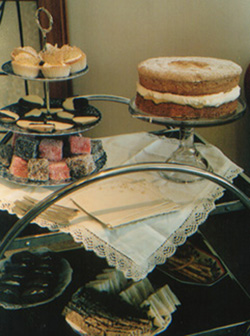 A stand filled with tea time cakes